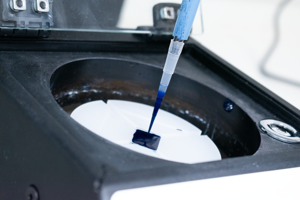 Solution being added to a spin coater