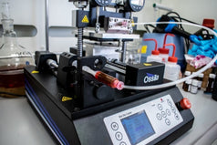 Filling a syringe with solution and connected it to the slot-die coater