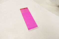 Coated substrate in a pink coloured solution