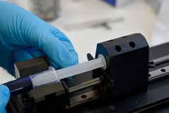 Attach the syringe using the clips